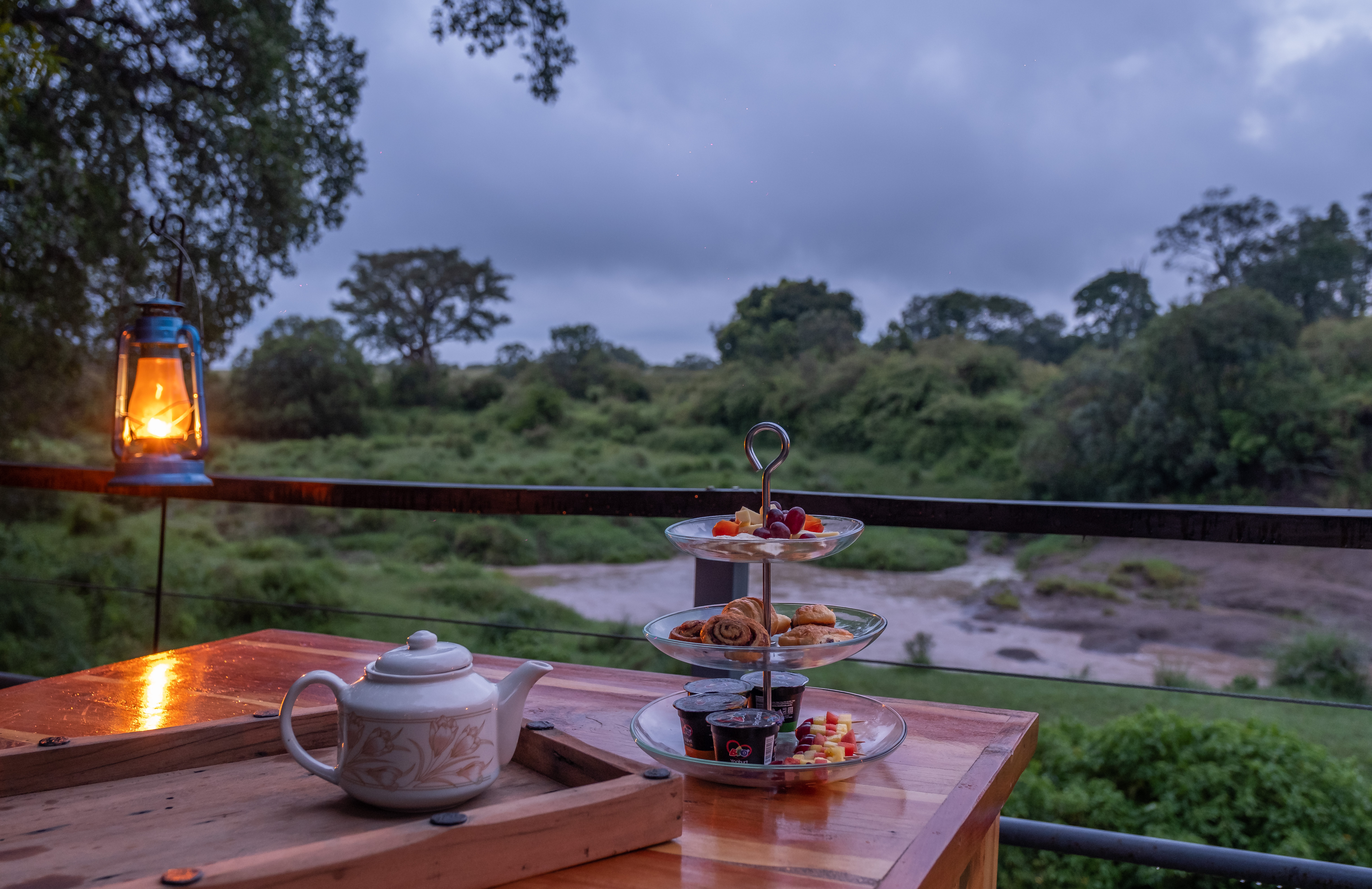 River-facing dining deck over the Olare Orok at dusk