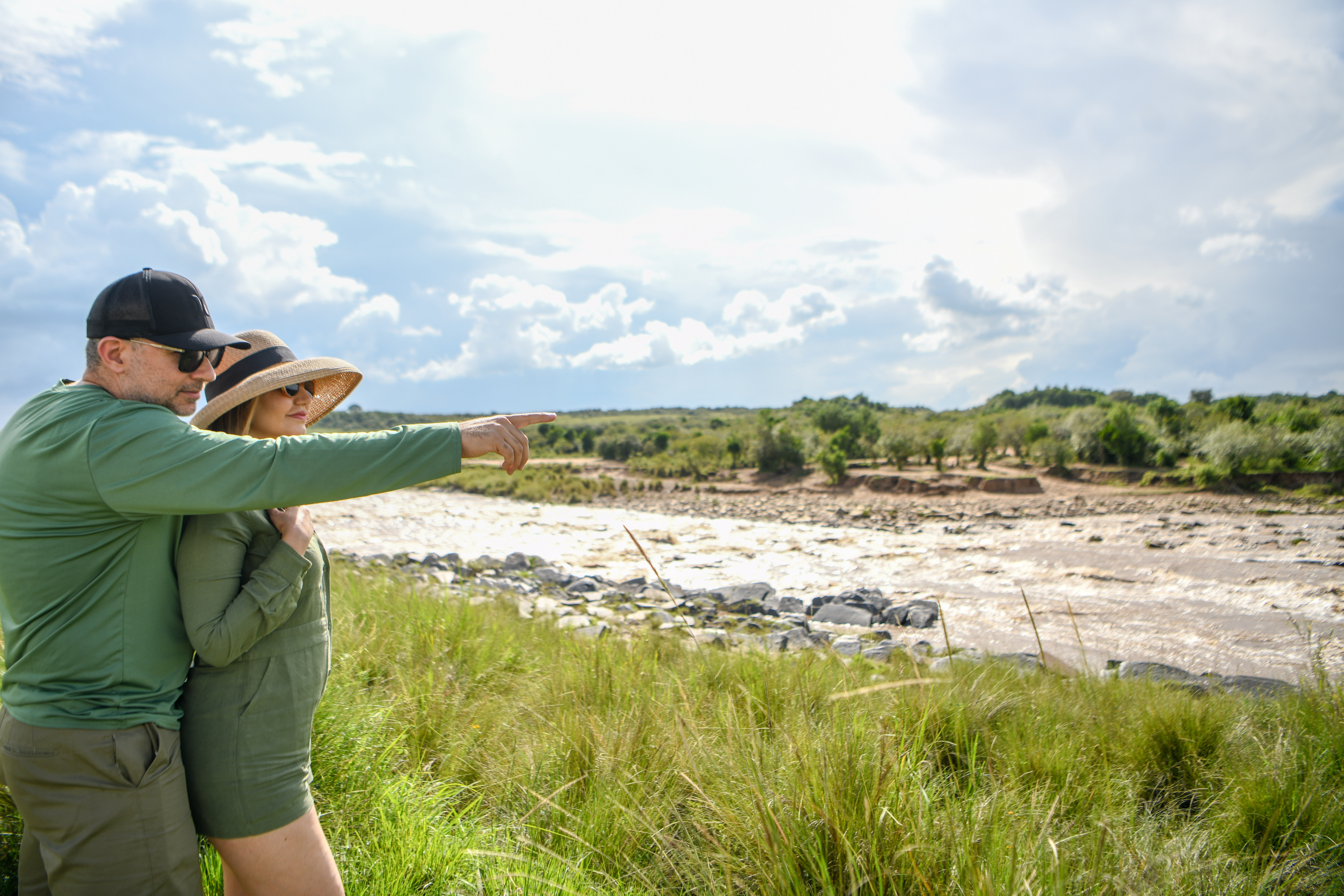 Couple looking out over the Mara River from the riverbank